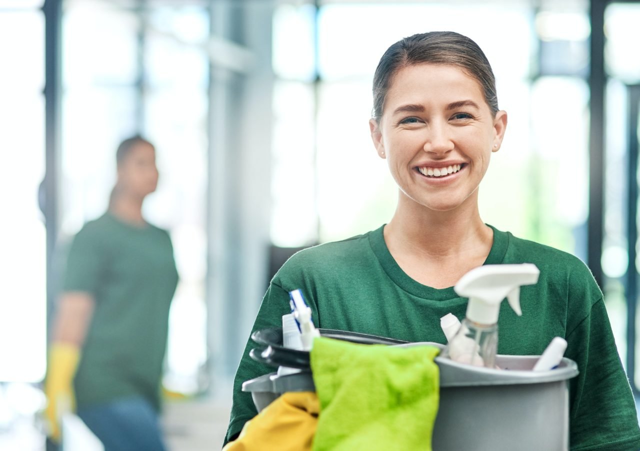 Smiling Grand Max cleaner carrying cleaning supplies